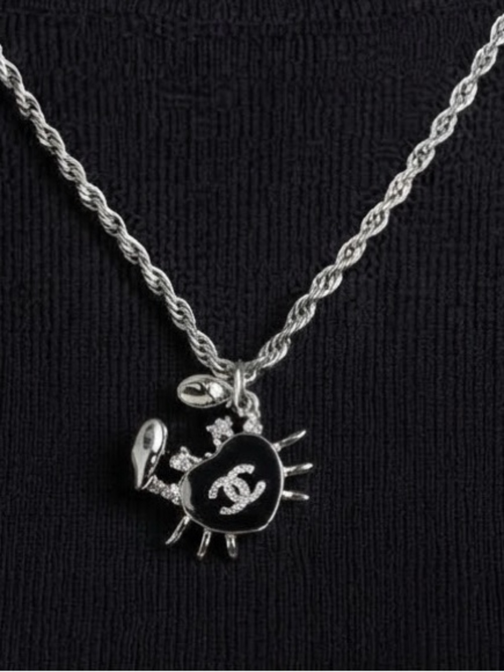 Chanel Silver-Tone stamped
Crab in black enamel &
Chrystal on 19" twisted rope